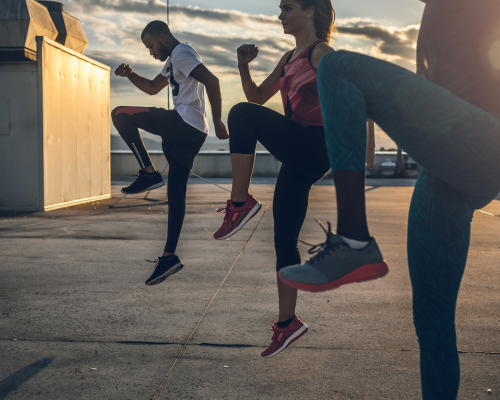 three people exercising outside
