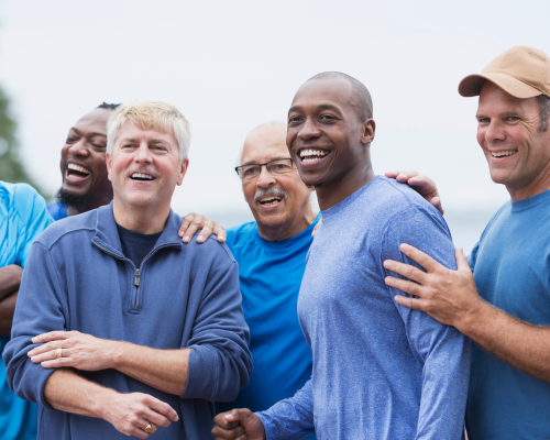 A group of men outdoors laughing