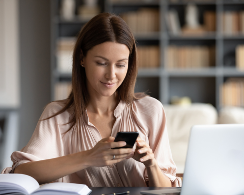 Woman on her device sitting down