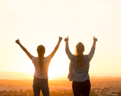 Two women celebrating outdoors