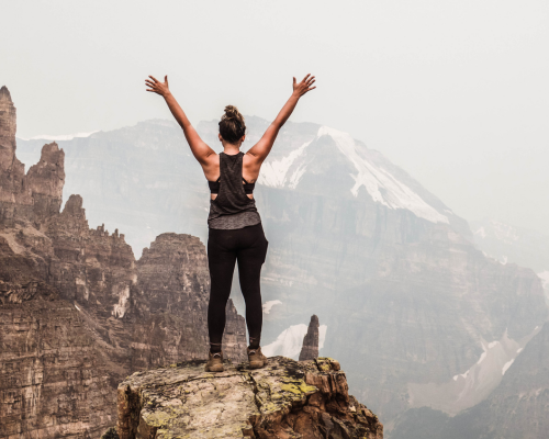 Woman posing on the top of a summit